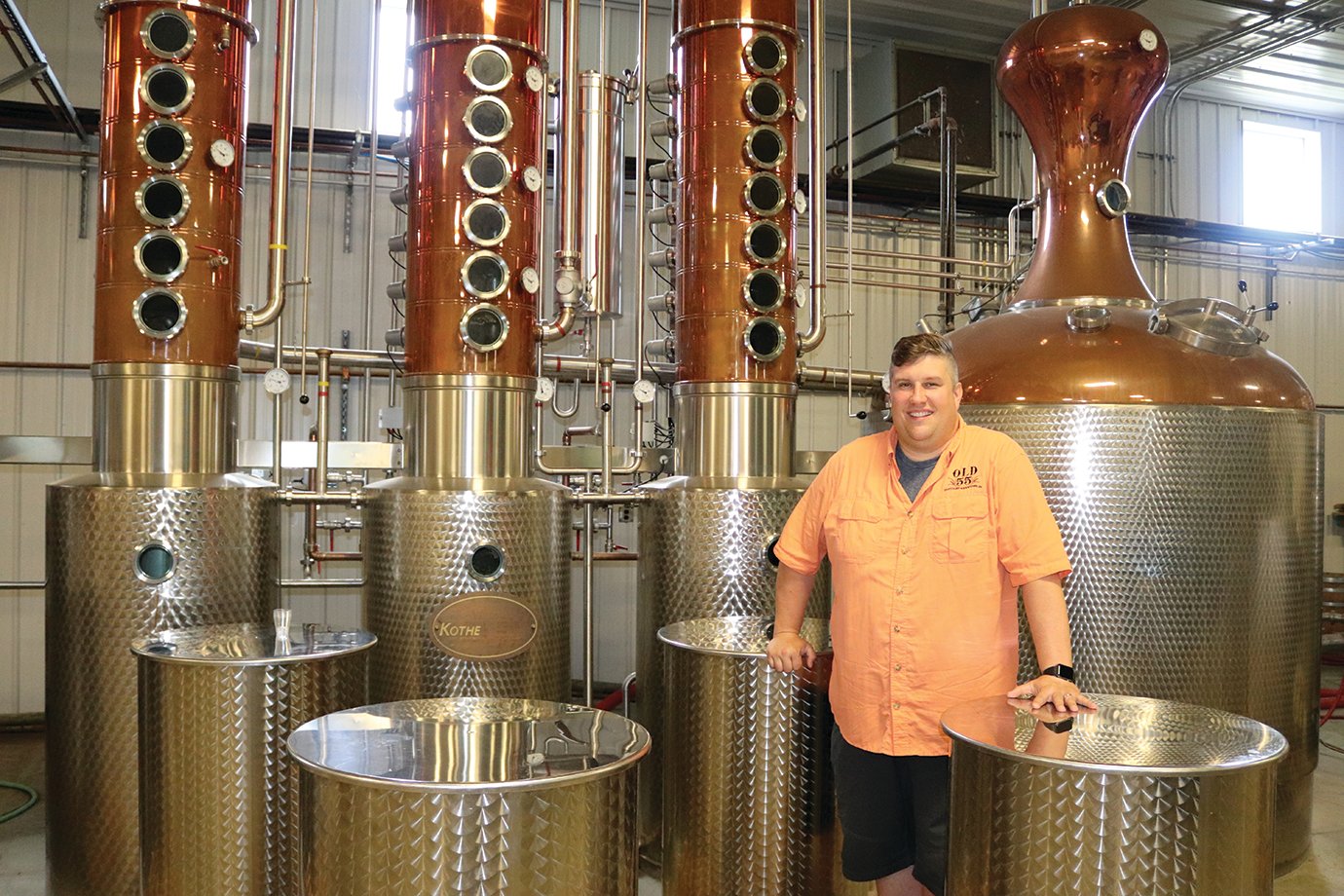 Old 55 Distillery CEO Jason Fruits displays the still at the Newtown distillery Friday afternoon. Made with imported equipment from Germany's Kothe Distilling Technologies company, the still has produced several bourbon whiskies which have received awards through the International Whisky Competition.