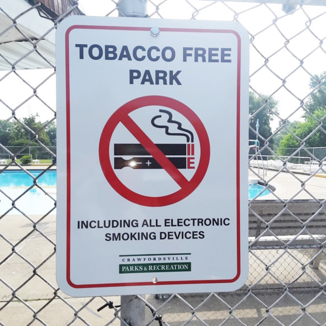 A sign designates the Milligan Park Pool as a "Tobacco Free Park." City officials and tobacco-free advocates are raising awareness of an ordinance that bans tobacco products, including e-cigarettes, in all Crawfordsville parks.