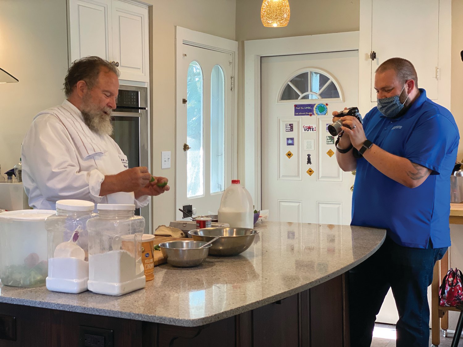 Dr. Richard Warner prepares a recipe as Chuck Ranspach films the scene. Warner is featured in the Dr. Mary Ludwig Montgomery County Free Clinic's "Dining with the Chefs: At Home Edition" on Aug. 8.