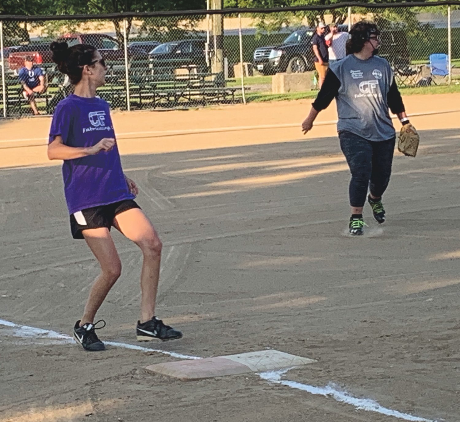Jessica Dowell rounds first base after a hit early in C&F Fabricating's championship game win on Tuesday. Waiting for a throw back into the infield is Gould/Stephenson/C&F pitcher Shawna Simmons.