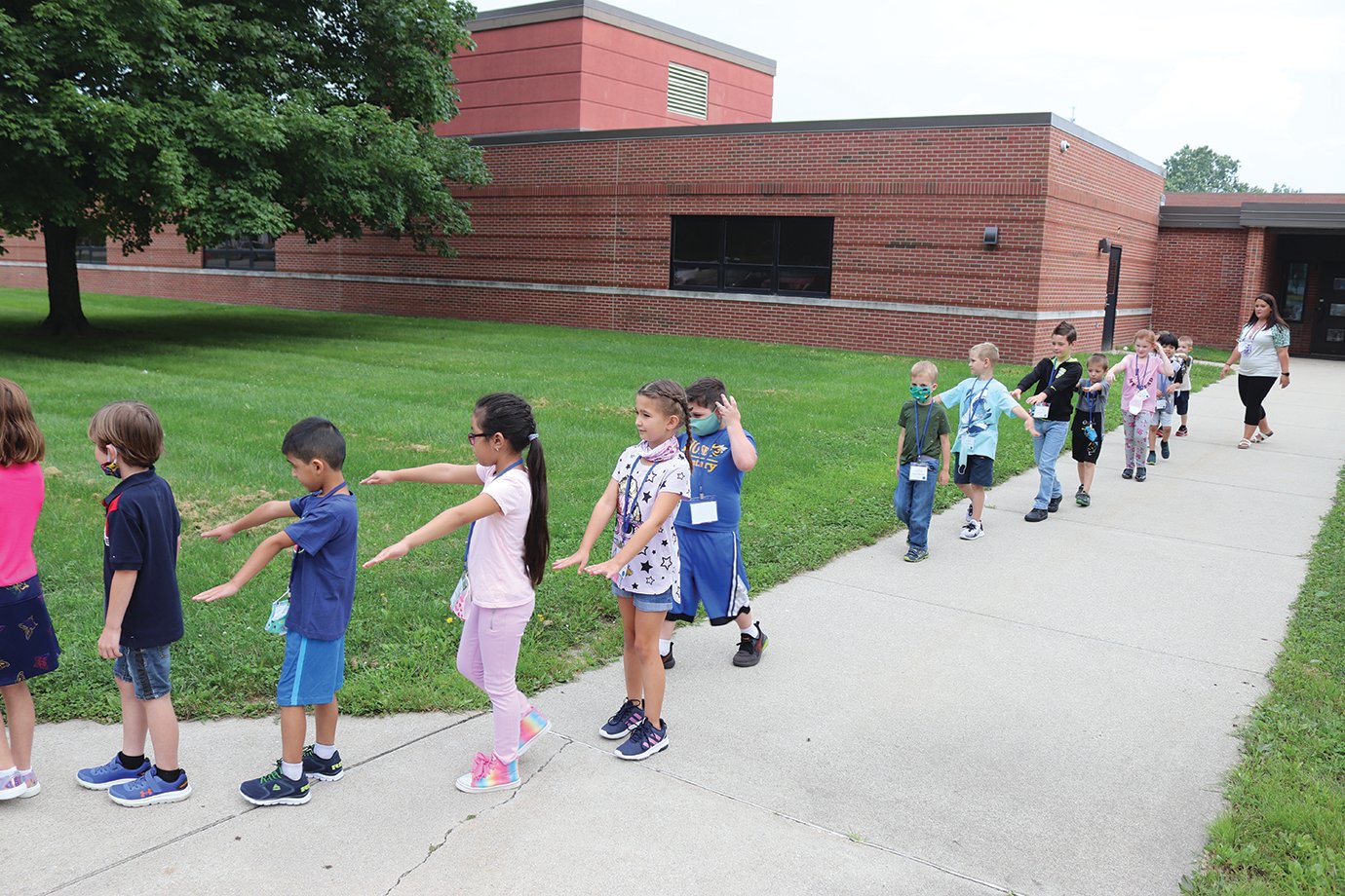 First-grade students from Jackie Voliva's class takes a break from the classroom Monday to take a walk outside. In doing so, students are also able to take a break from wearing their masks as many are still becoming familiar with the concept.