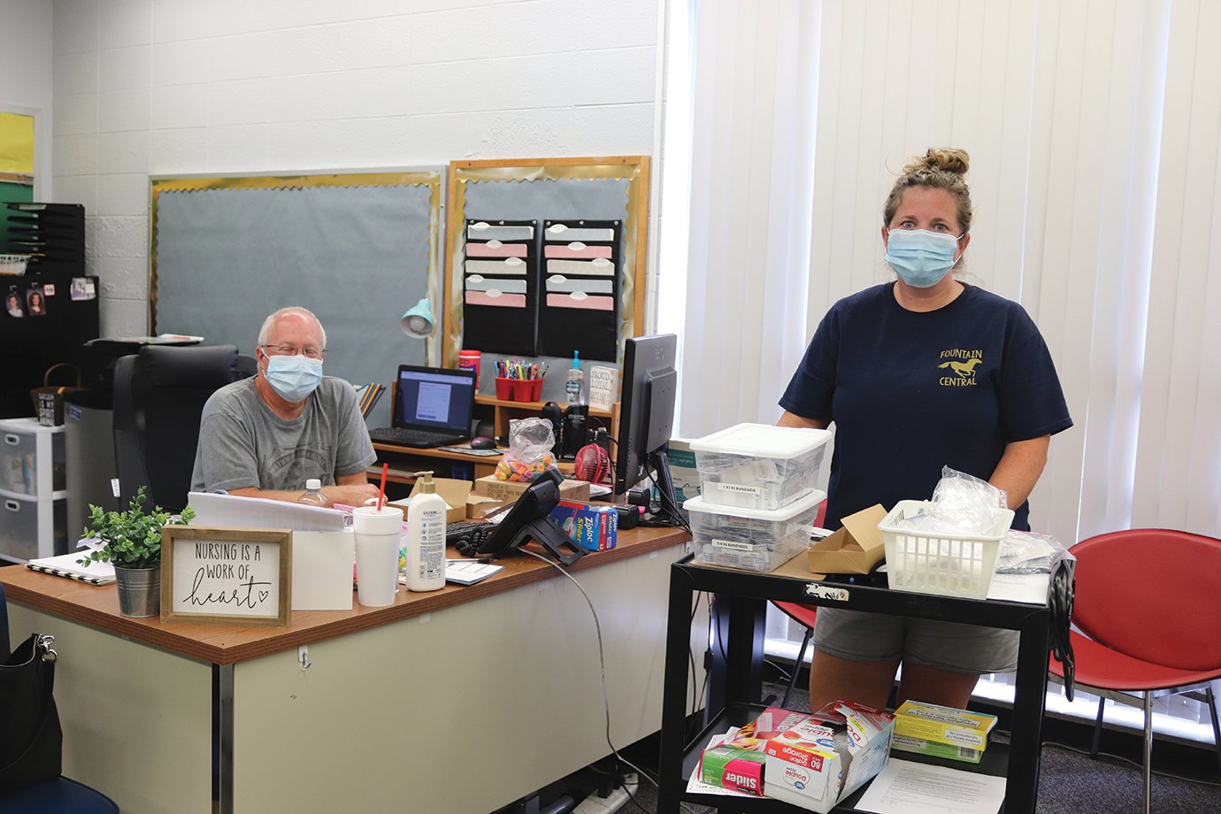 Fountain Central nurse Lori Myers, right, and husband Todd make final preparations Tuesday ahead of the district’s first day of school.