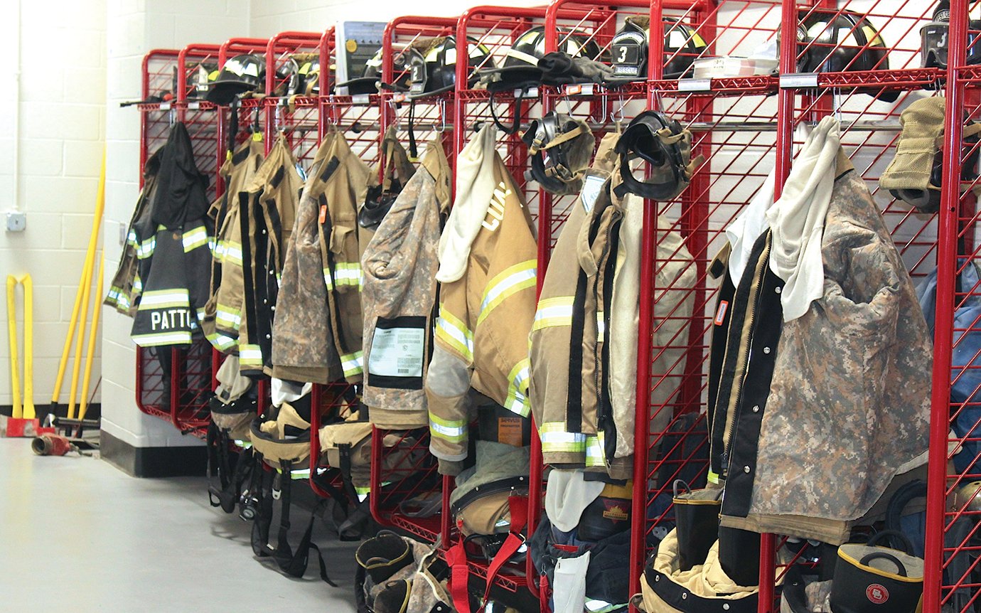 Fire-resistant clothing, uniforms and other equipment line south wall in Southmont's firefighting and emergency medical services bay, awaiting a call to action from students participating in the vocational class offered to North Montgomery, Crawfordsville, Southmont and Western Boone schools.