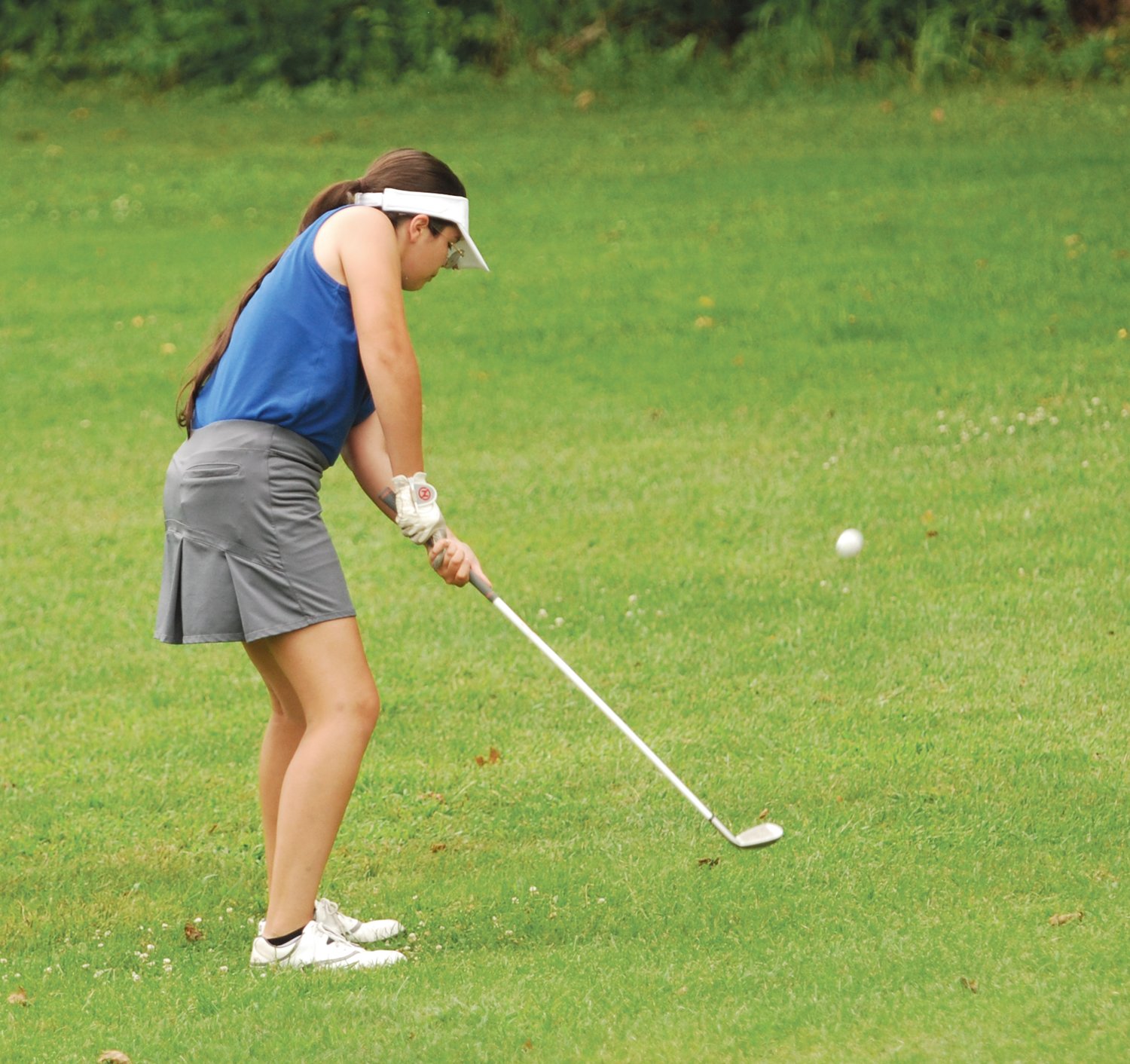 Crawfordsville's Evie Redding chips a shot toward the green on Thursday evening at Crawfordsville Municipal Golf Course. The senior fired a 55.