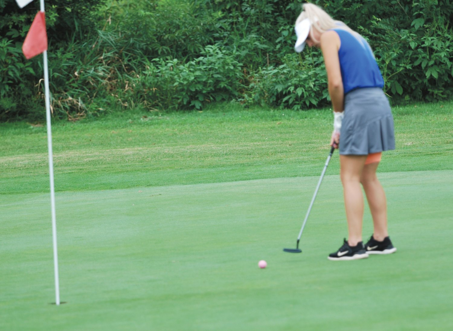 Crawfordsville's Sadie Walker putts during a match with University and Covington on Thursday evening at Crawfordsville Municipal Golf Course.