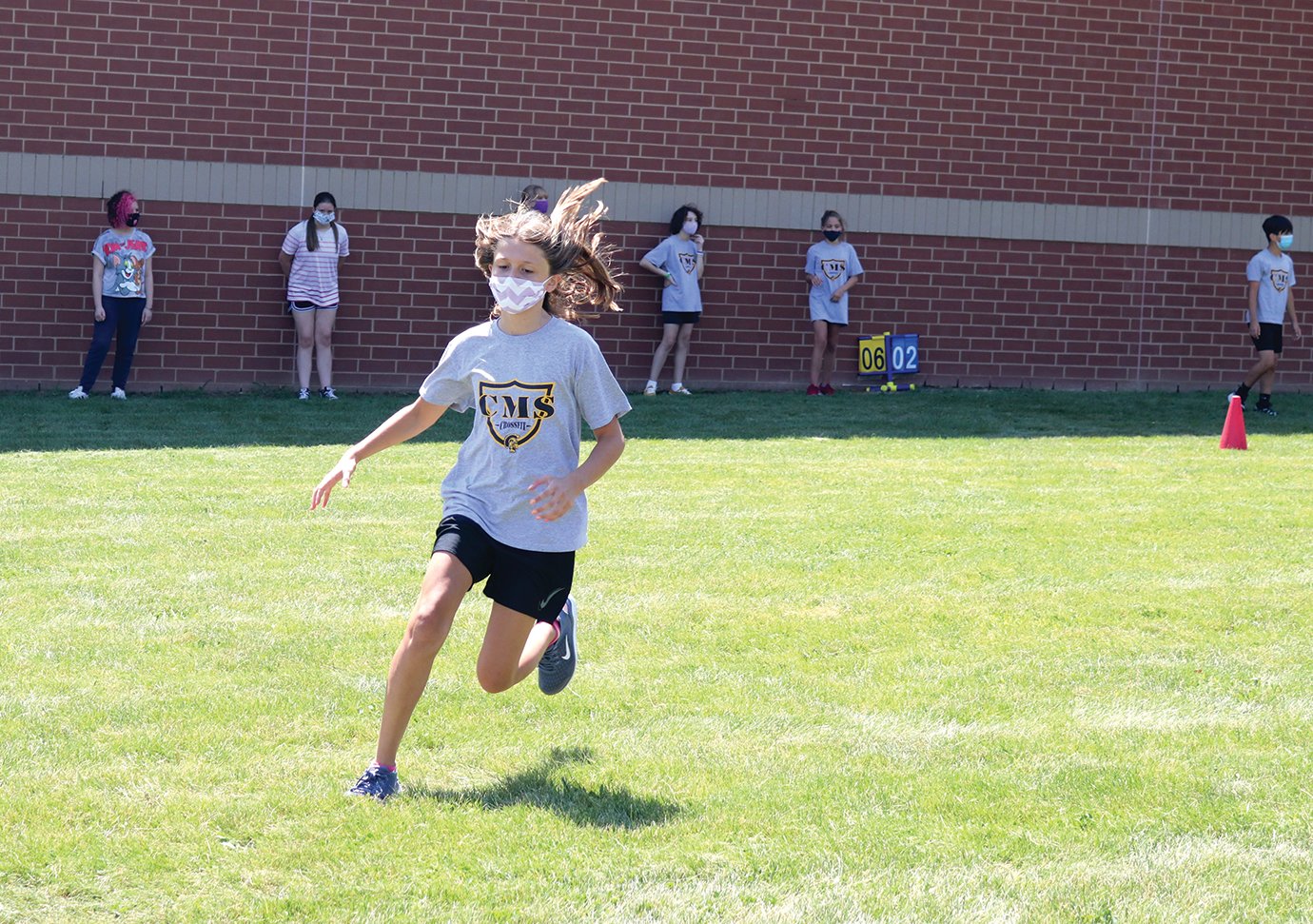 Sixth-grade student Sydney Elizonzo heads to first base Tuesday during a cardio softball game at Crawfordsville Middle School in which students play timed innings instead of counting "outs."