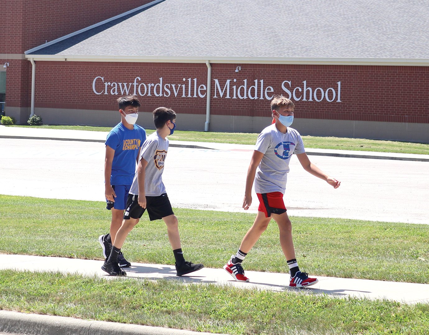 Seventh graders Jaziel Gil Herrera, from left, Hayden Craig and Maddox Ball lead the pack Tuesday at Crawfordville Middle School during a physical education warm-up walk.