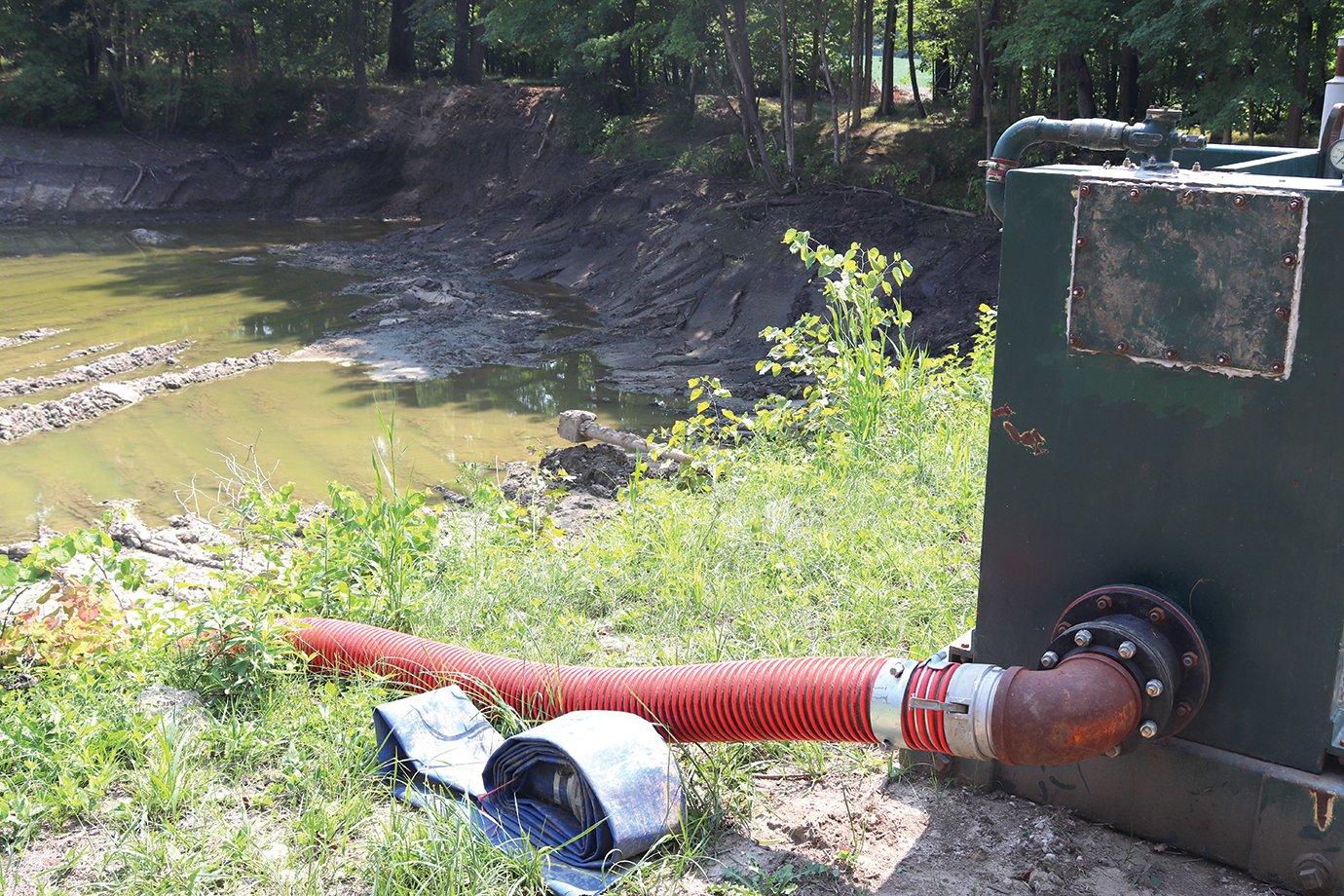 An industrial-sized pump sits idle after draining the pond at the Darlington Conservation Club earlier this week. Water removed from the pond was emptied into a ravine which in turn empties into Sugar Creek closeby.