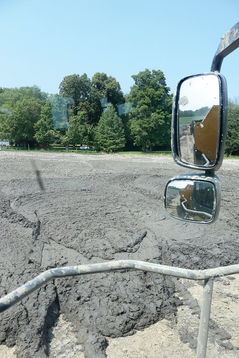 An expansive deposit of silt and mud from the Darlington Conservation Club pond dries in 90-degree temperatures Tuesday south of the club.