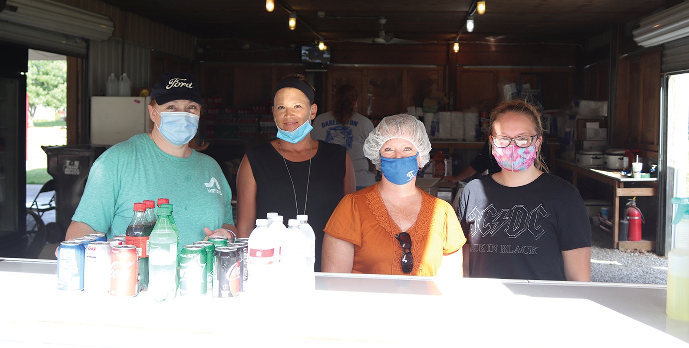 Laurie Bane, from left, Kelly Needham, Nancy Thomas and Kayla Thomas serve up pork sandwiches, sloppy Joes, coneys and more Saturday at Tremaine Park.