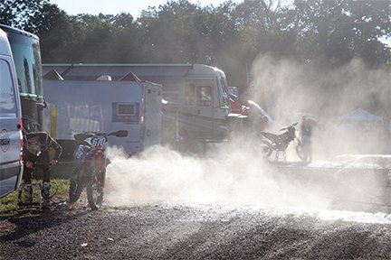 Riders spray off their bikes at the Ironman Pro Motocross on Saturday.