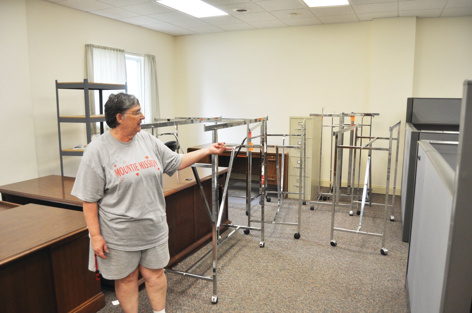Diane Cross, founder of Mountie Mission, points to cubicles in a vacated Hoosier Heartland State Bank building the agency plans to purchase for additional space.