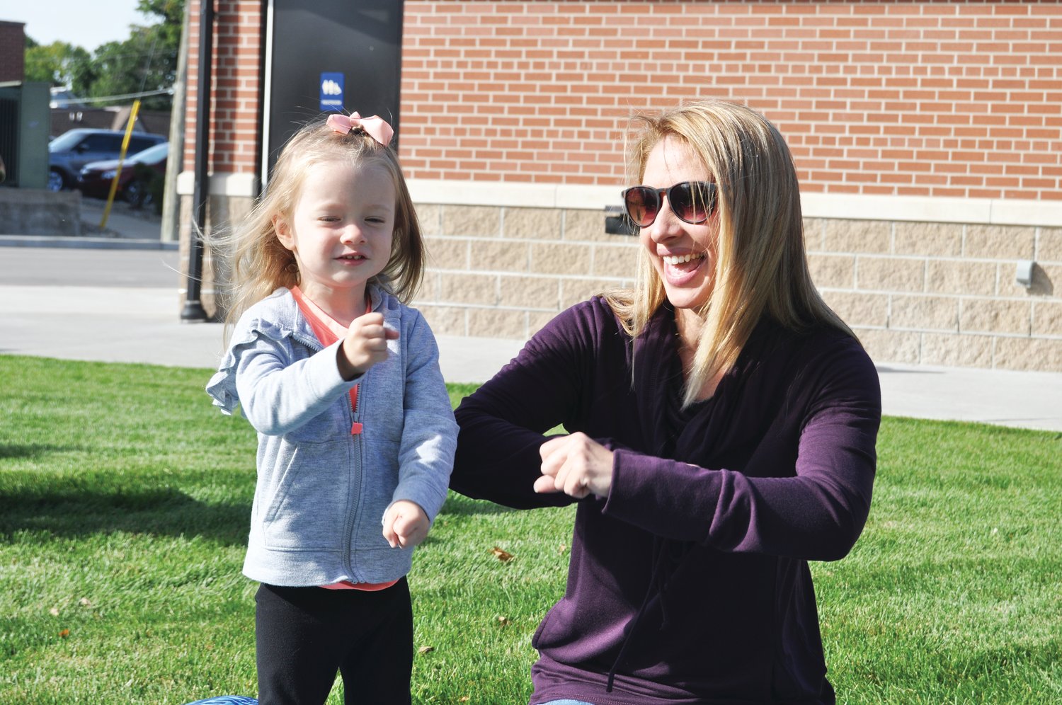 Ella Rauch, 2, and her mother Bethany do the motions to a song Friday during Crawfordsville District Public Library's Wiggle & Giggle program at Pike Place. The drop-in program is open to children ages 18 months to 4 years.