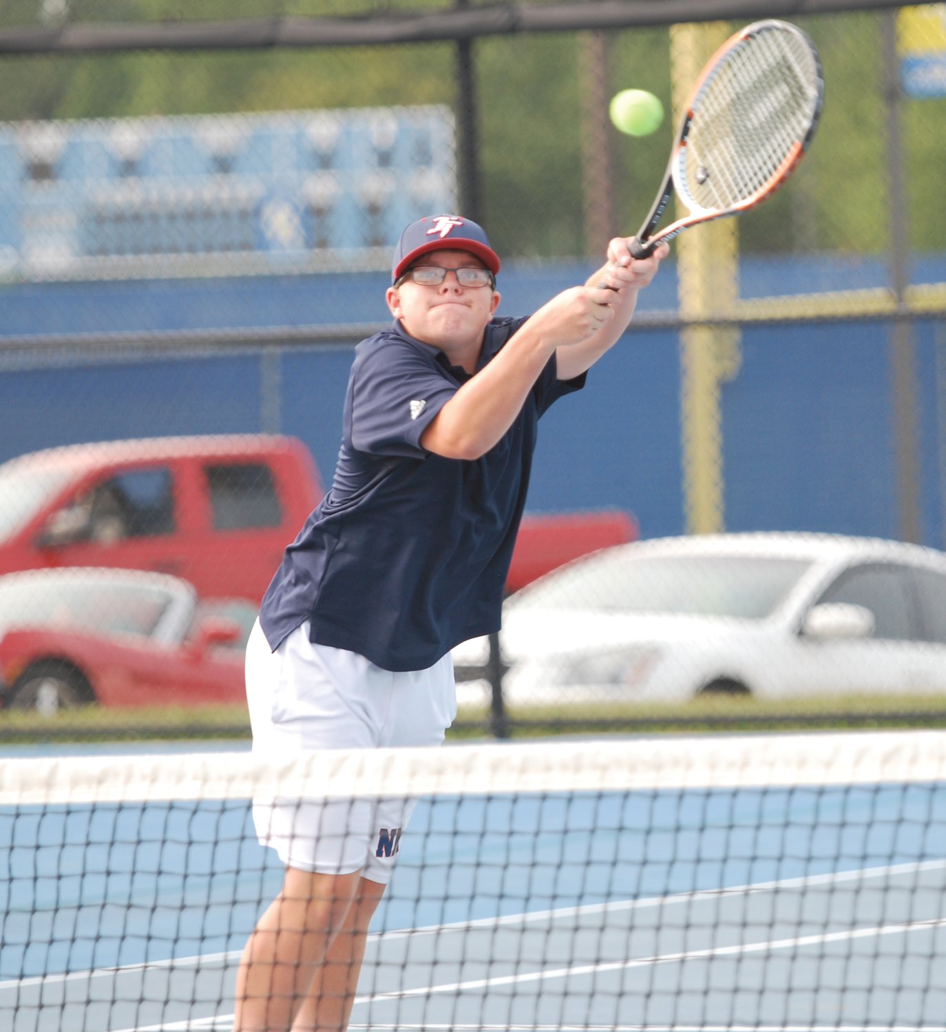 North Montgomery's Hayden Turner returns a shot on Monday during his No. 2 doubles match against Crawfordsville.