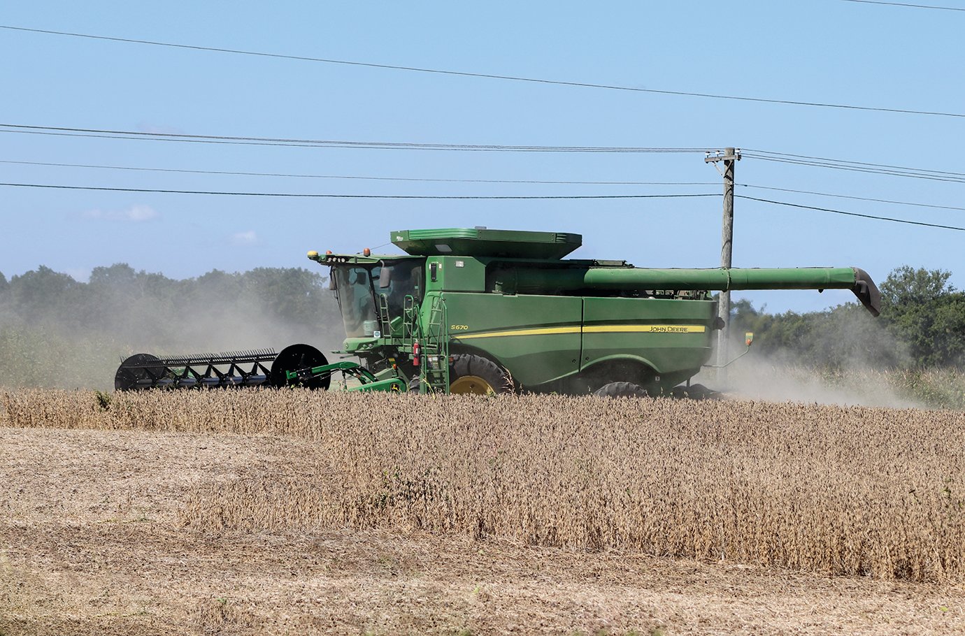 A farmer operates a combine in a field on C.R. 150S west of Crawfordsville High School.