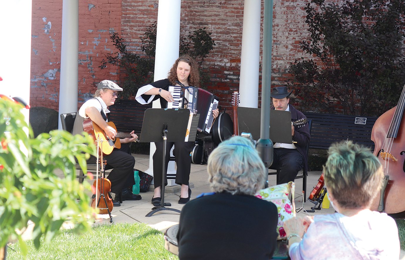 A local musical group called the Bal-Hinch Bunch performs Friday for patrons of Lunch on the Plaza event at the Marie Canine Plaza. A trio of the group's evolving membership were present for Friday's lunch, including Clayton Peters, from left, Josie Beach and Dennis Beach.