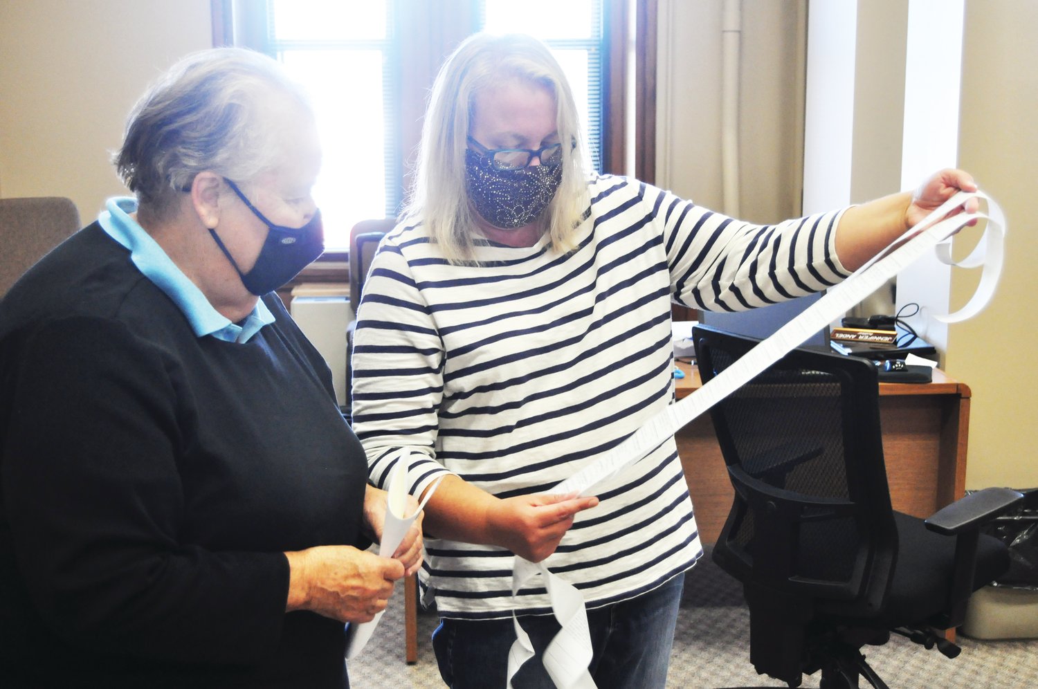 Montgomery County Clerk Karyn Douglas, right, shows tape from a voting machine test to Democratic election board member Virginia Servies Friday at the Montgomery County Courthouse. The state-required test ensures the machines are working properly for voters.