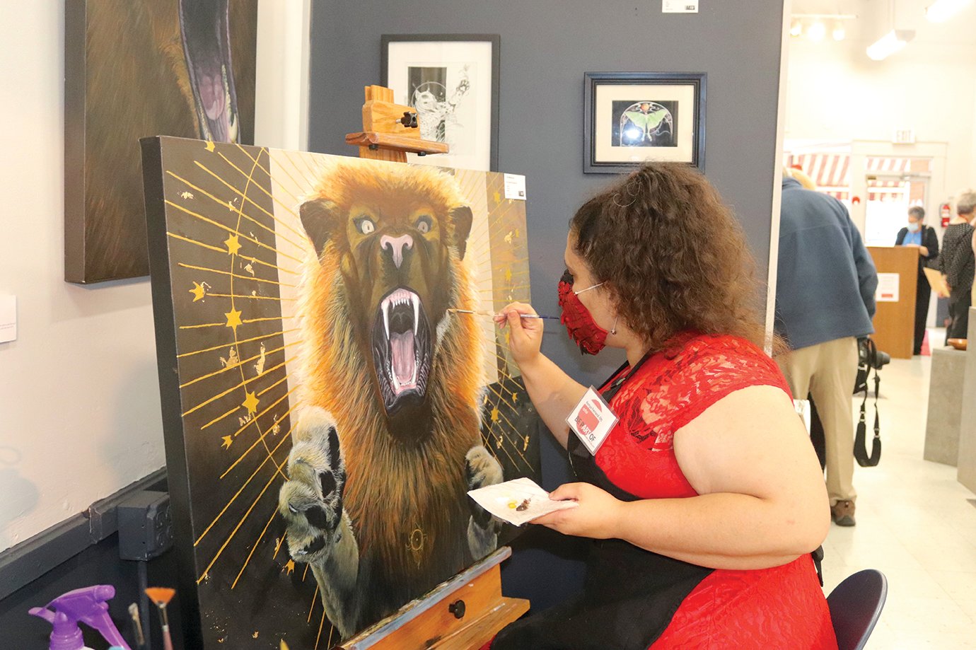 Athens Arts Gallery member artist Kenya Ferrand-Ott paints a manticore Sunday during an open house and fundraiser for the studio.