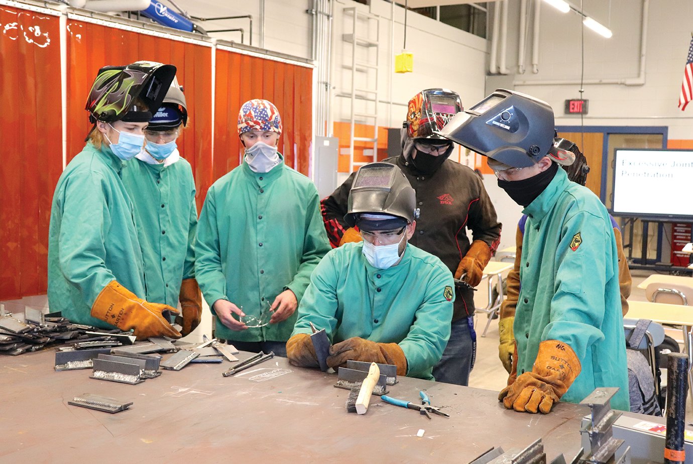 Students enrolled in a new welding program at North Montgomery High School, in collaboration with West Central Indiana Career and Technical Education Center, observe the technique of veteran instructor Jeff Harp, seated, inside the school's renovated manufacturing wing. Students alongside Harp include Gavin Haltom, from left, Noah Hudeson, Sean Kilgour, Jarrett Weder, Timothy Coffman and Nate Gray.