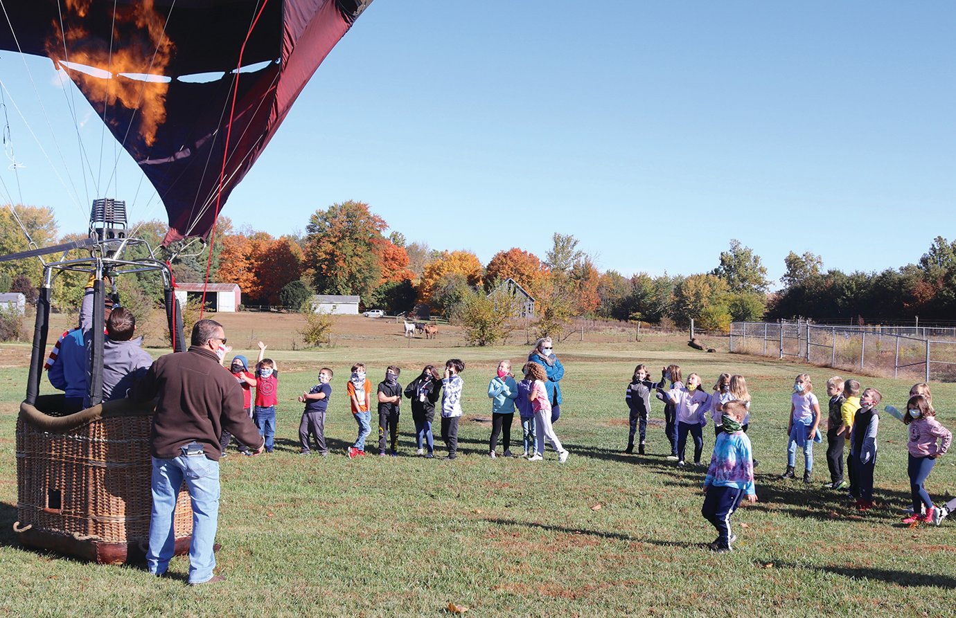 Second-grade students at Walnut Elementary experience a hot air balloon up close Tuesday. The idea to bring a field trip to the students is the result of a team effort between South administrators and members of the district's Parent-Teacher Organization to supplement a canceled carnival and annual trips in light of the coronavirus (COVID-19) crisis.