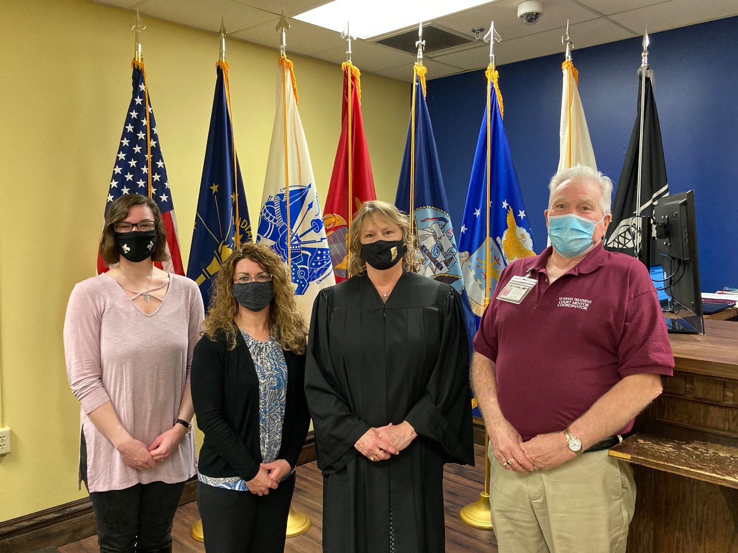Members of the Montgomery County Veterans Treatment Court, from left, case manager Ashlee Waling, probation officer Jennifer York, Judge Peggy Lohorn, and mentor coordinator Mike Spencer stand in the courtroom.