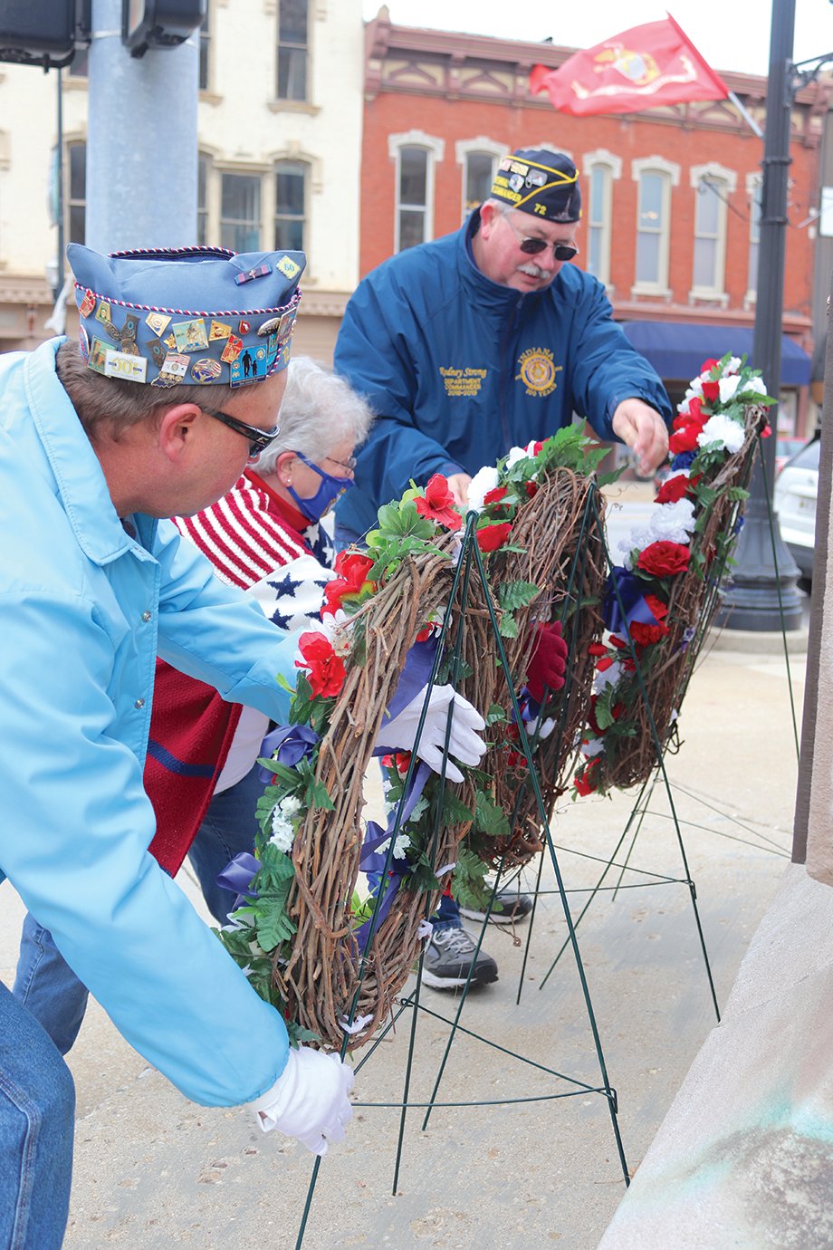 Keith Switzer, from left, Rosemary Hutchison and Rodney Strong place wreaths at the base of the Soldier's and Sailor's Monument in downtown Crawfordsville; the trio, which represents the Sons of the American Legion, Legion Auxiliary and Legion Post 72, respectively, performs the act every November on Veterans Day.