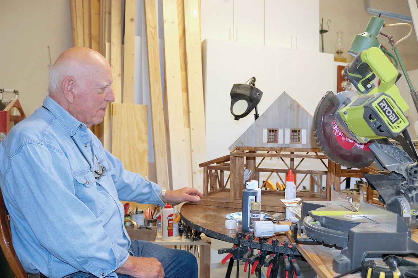 Richard Peterman sits in his home workshop Wednesday to show what it's like to build his renowned Santa Houses each year for the holiday season.