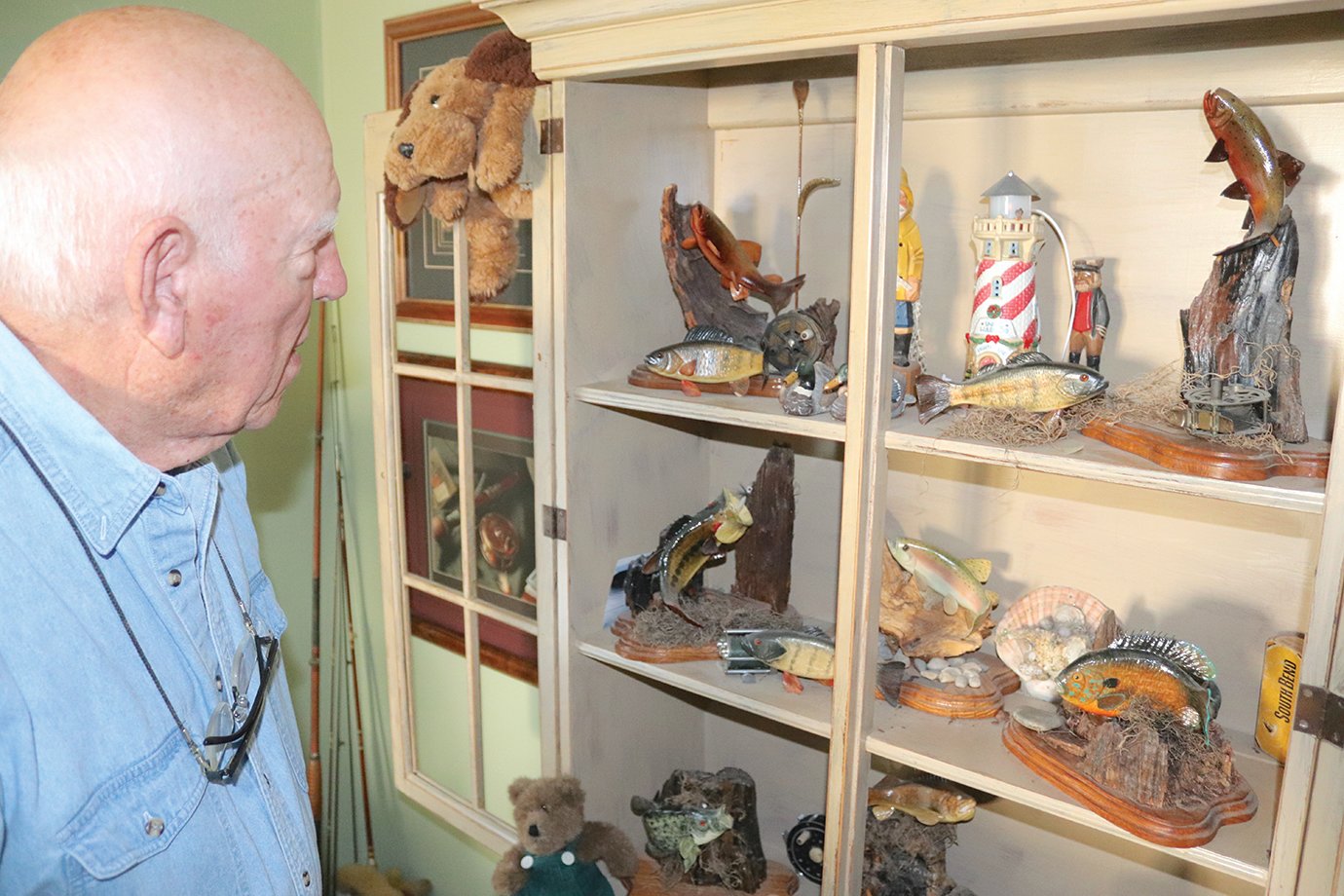 Richard Peterman views a number of fine artwork he's created over the years at his Crawfordsville home Wednesday; Peterman's talents go well beyond annual Santa Houses proudly displayed by city businesses and organizations each year.