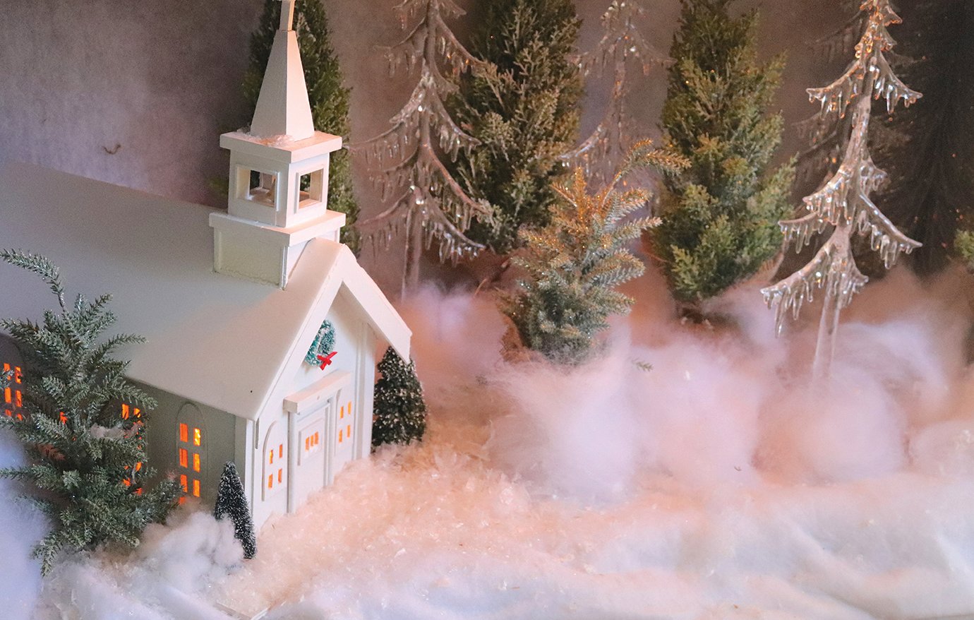 A minature church created by Richard Peterman is depicted in a winter wonderland as part of a decorative piece adorning the Peterman home.