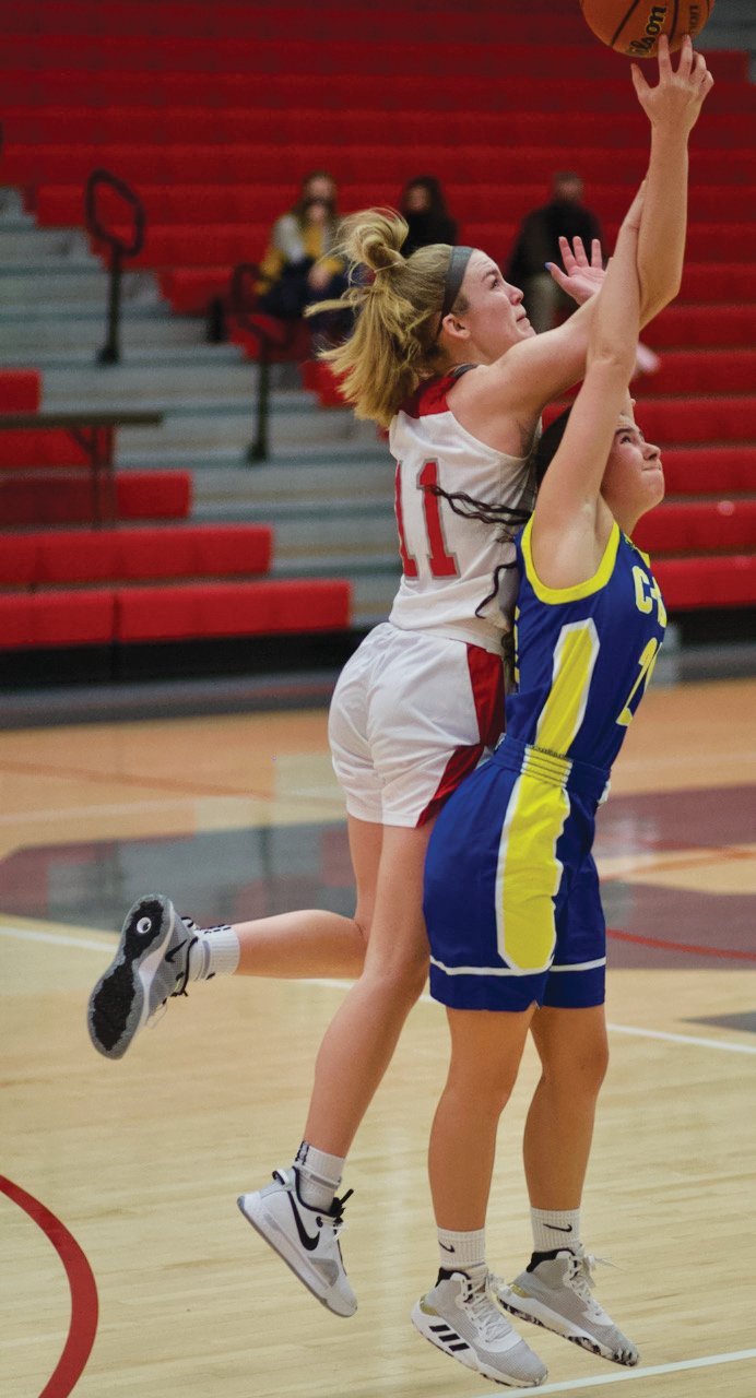 Southmont’s Sidney Veatch battles for position with Crawfordsville’s Liddy McCarty. Veatch scored 12 points in the Mounties 43-37 overtime win over the Athenians in the Sugar Creek Classic title game.
