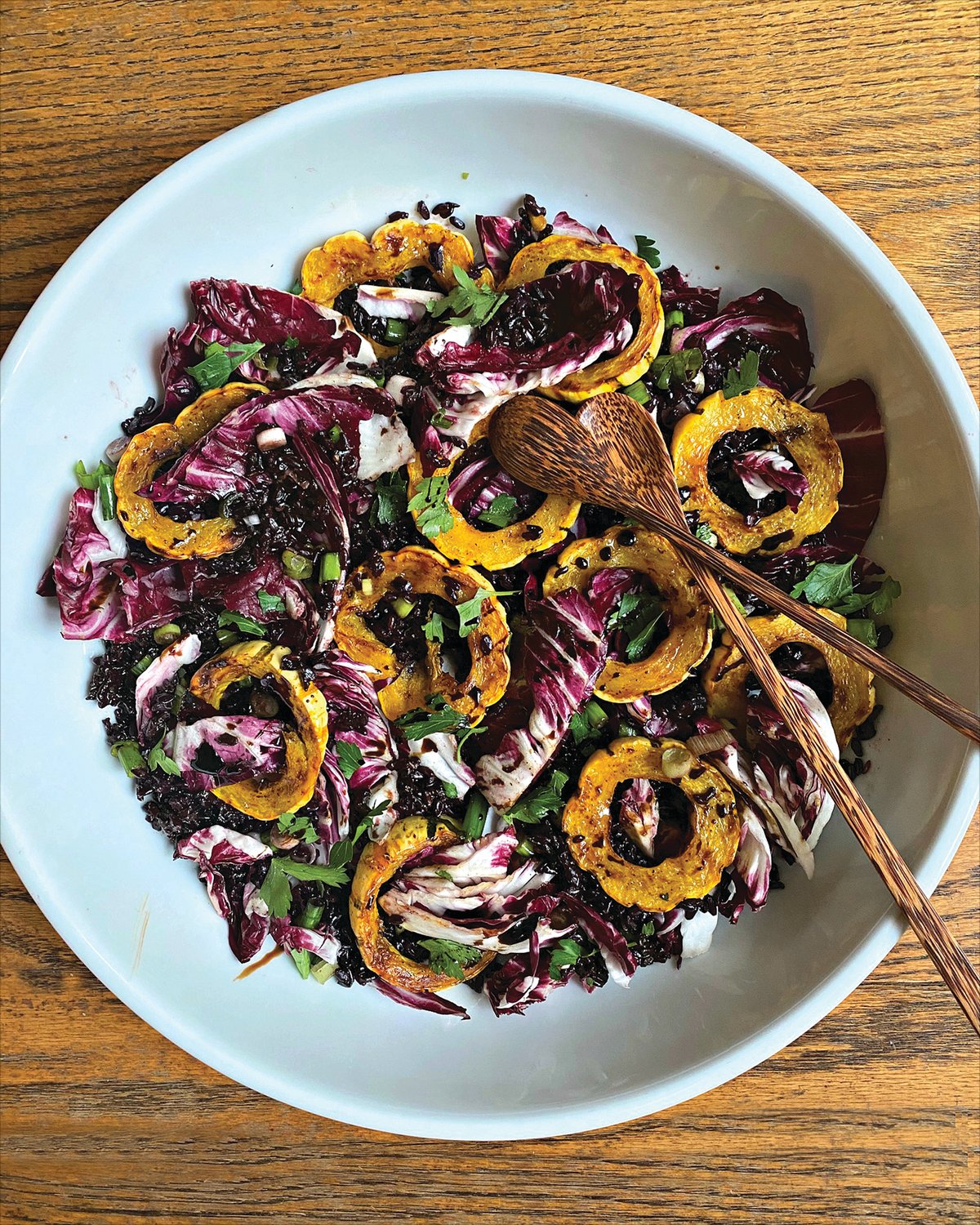 This vibrant salad is a layered with toothsome nutty black rice, juicy-crisp radicchio leaves, and spice-roasted delicata squash rings.