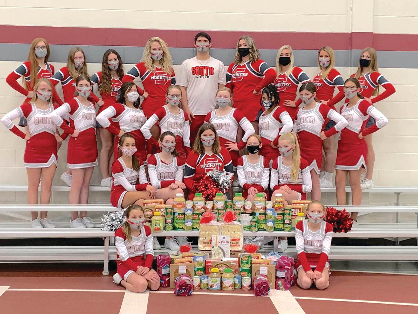 The Southmont cheerleading squad poses for a photo ahead of delivering traditional Thanksgiving meal ingredients to the organizers of the Community Thanksgiving Dinner.