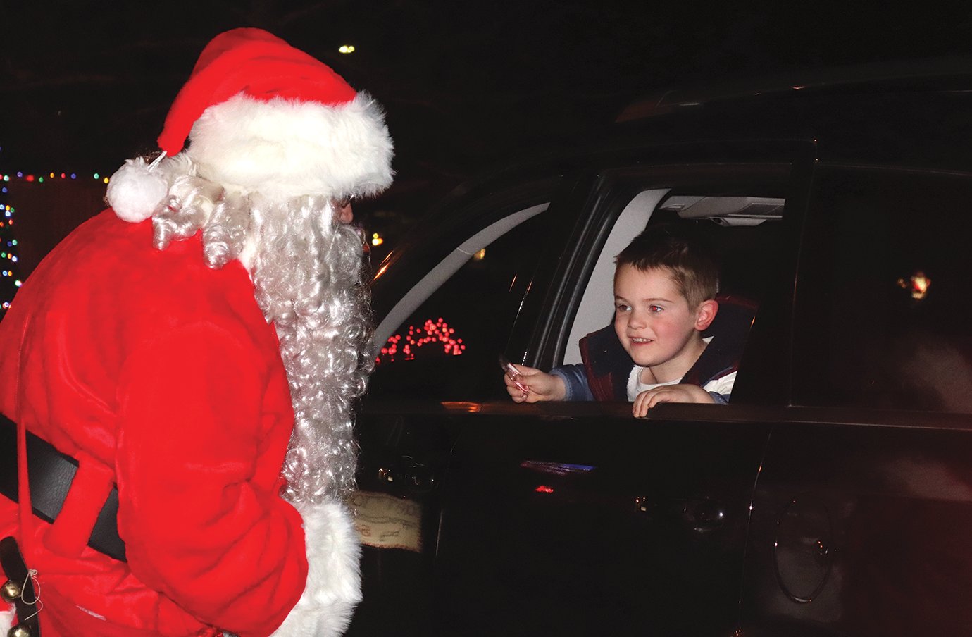 Santa deputizes Sawyer Pierce as one of his little helpers Saturday during Christmas in the Park.