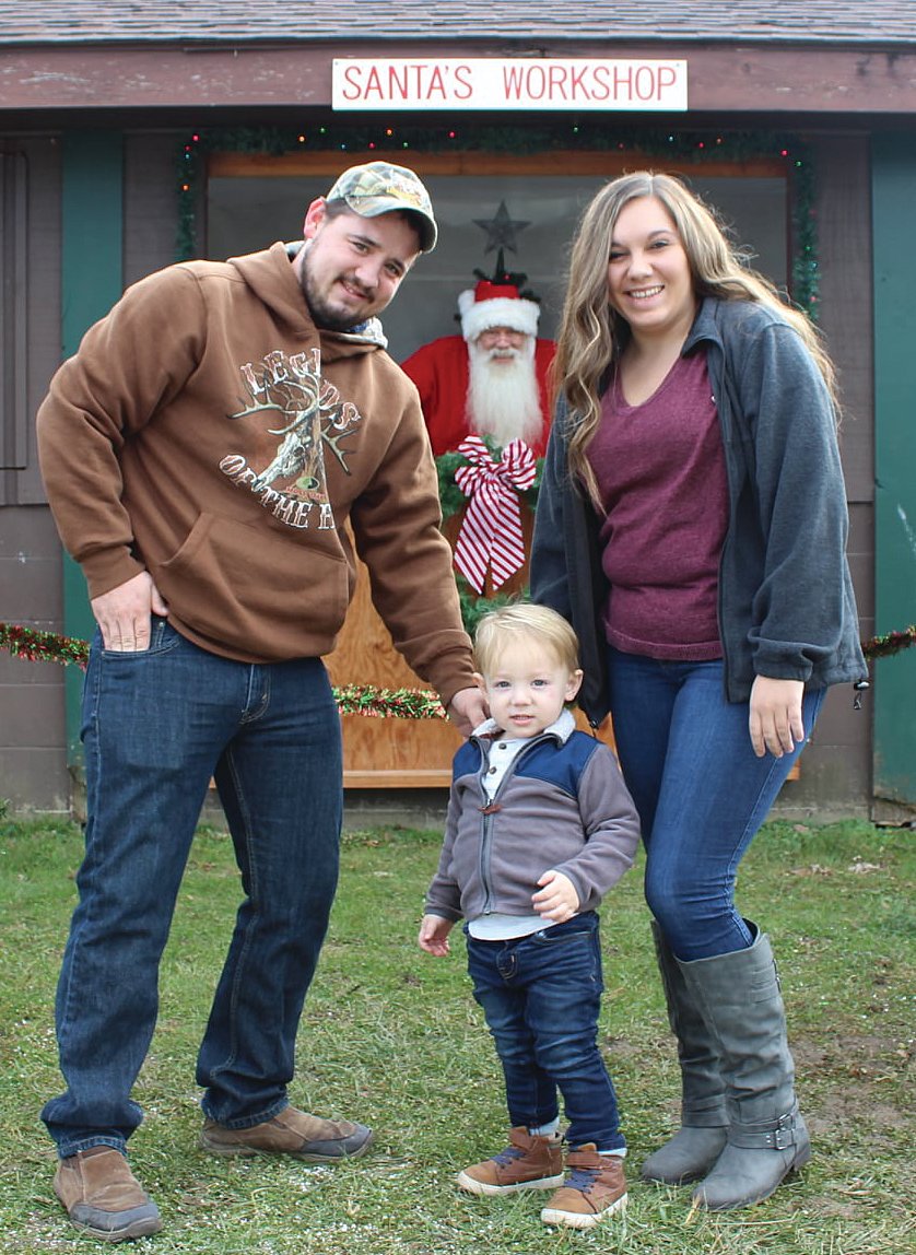 Derrick Roe, Christa Overshiner and son Landon Roe enjoy a visit with Santa.