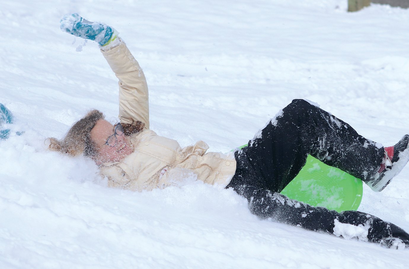 Parker Church wipes out on her sled.