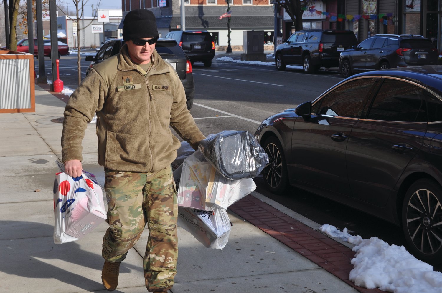 Staff Sgt. William Earley of the Indiana Army National Guard carries toys dropped off at the Journal Review for Operation: Toy Box on Friday. The program — a collaboration between the Crawfordsville unit of the guard, REINdear program and Crawfordsville Kiwanis — has provided gifts for an estimated 6,300 children over 26 years.