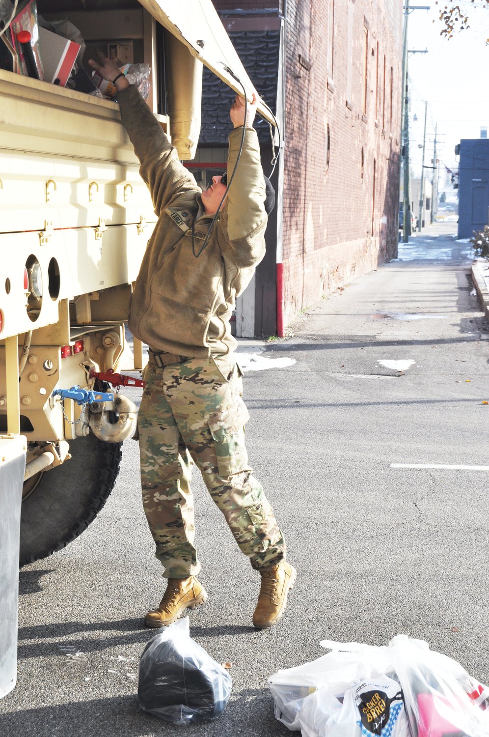 Staff Sgt. William Earley of the Indiana Army National Guard loads up donations from Operation: Toy Box Friday outside the Journal Review. The newspaper was a collection site for the annual program.