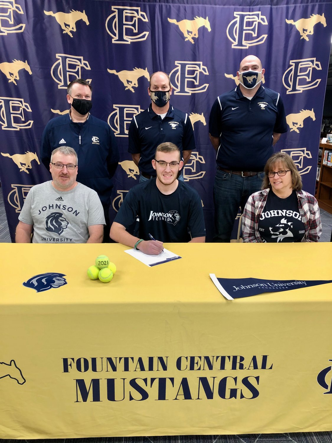 Jacob Keeling is joined by his parents BJ and Lisa Keeling to celebrate his commitmnt to play tennis at Johnson University. Also pictured is Fountain Central athletic director Jason Good and tennis coaches Chris Webb and David Kight.