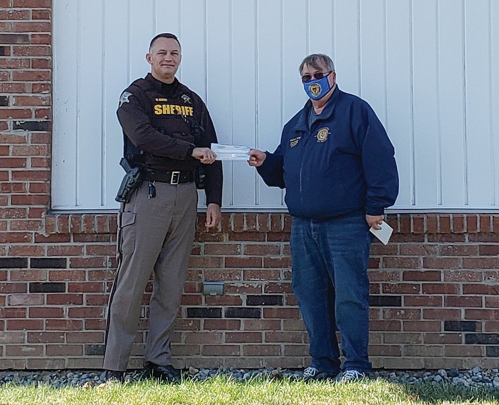 Mike Kersey, left, representing the SWAT team, accepts a check from Rodney Strong.