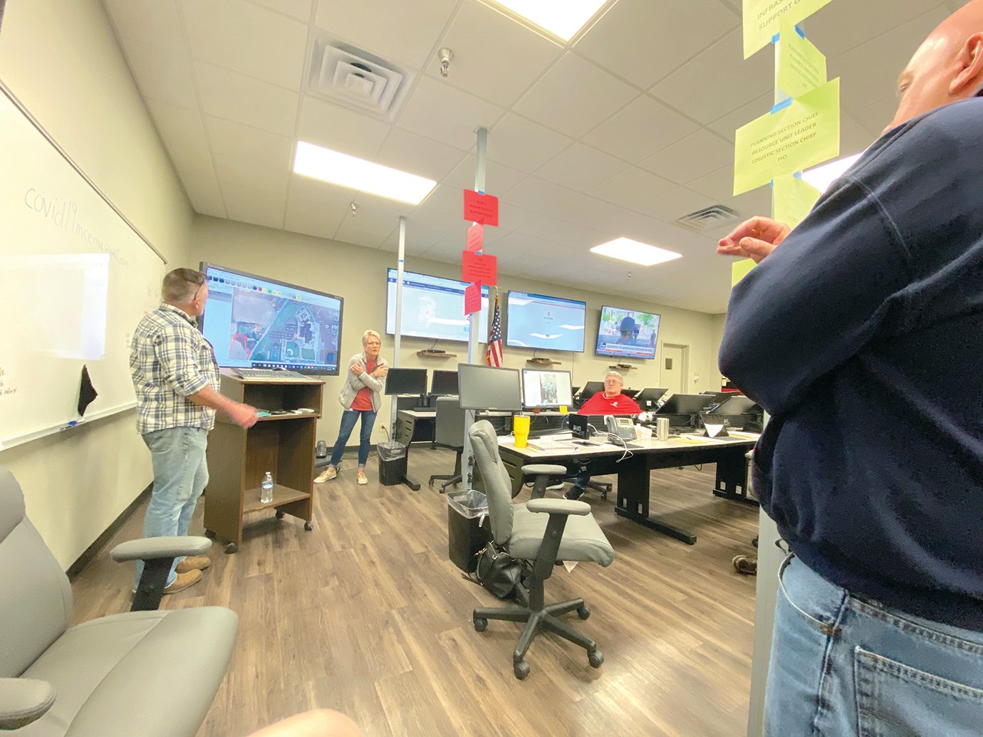 Montgomery County Health Department Administrator Amber Reed discusses plans for a drive-through testing site with EMA Deputy Director Brian Campbell (left) and Crawfordsville Mayor Todd Barton (right) at the Emergency Operations Center at the EMA Building on Sunday, March 22.