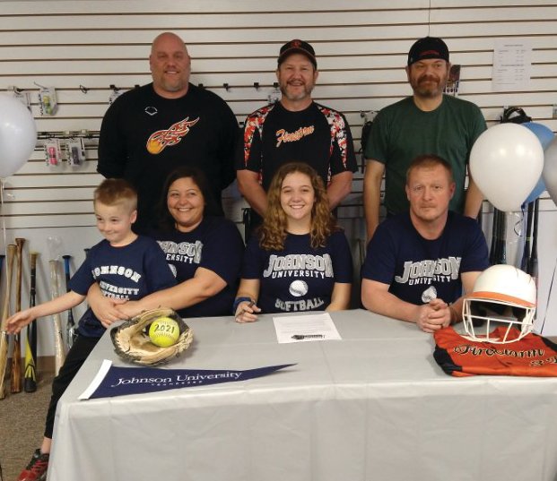 Local softball player Adison Hawk was joined by family and coaches to celebrate her commitment to Johnson University.