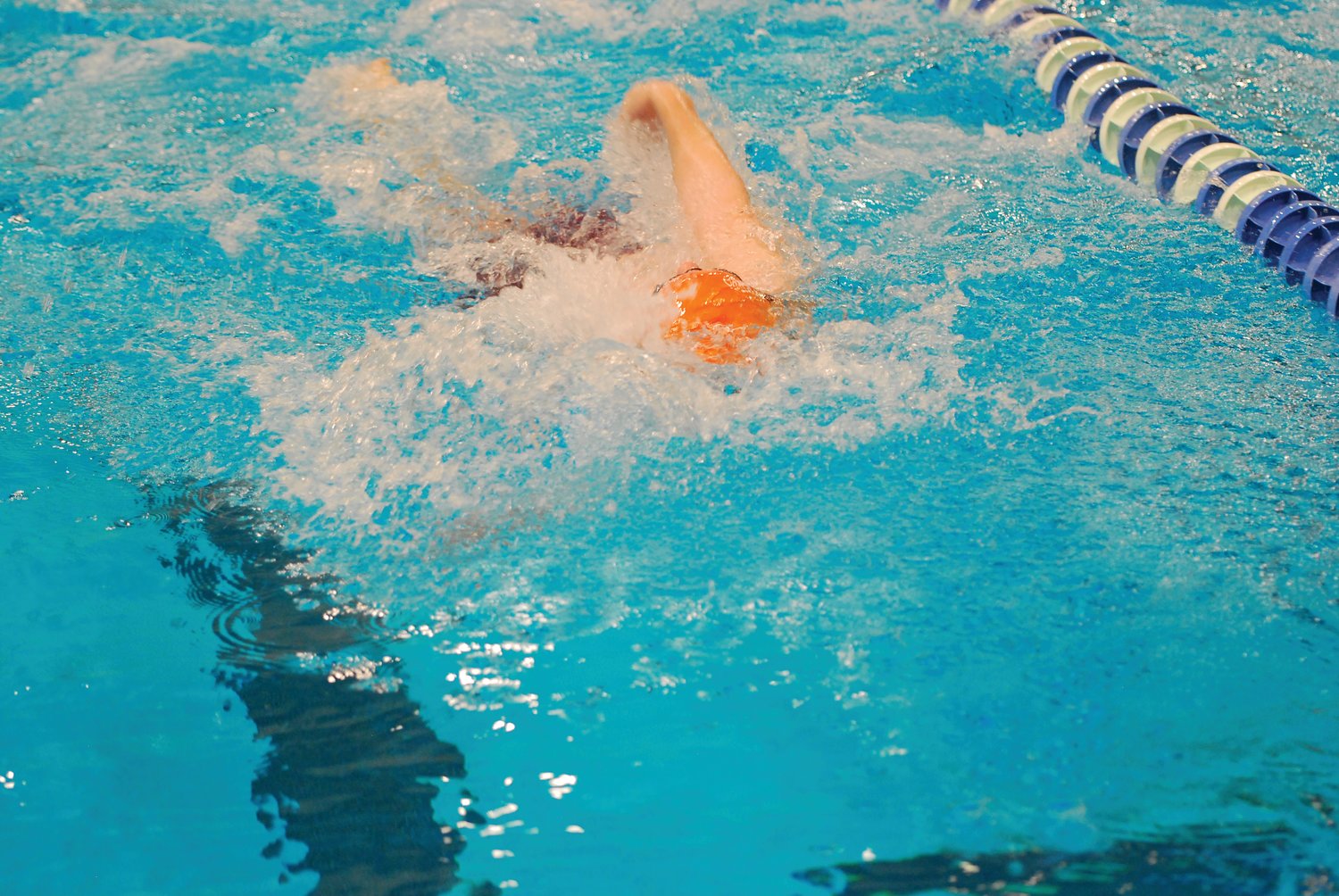 North Montgomery's Jamason Burget competes in the 100 backstroke.