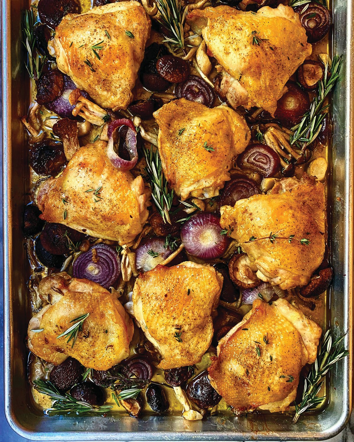 A sheet pan dish is simply that — a complete meal assembled on a pan and plopped in the oven, where the meat, vegetables and aromatics mingle together.