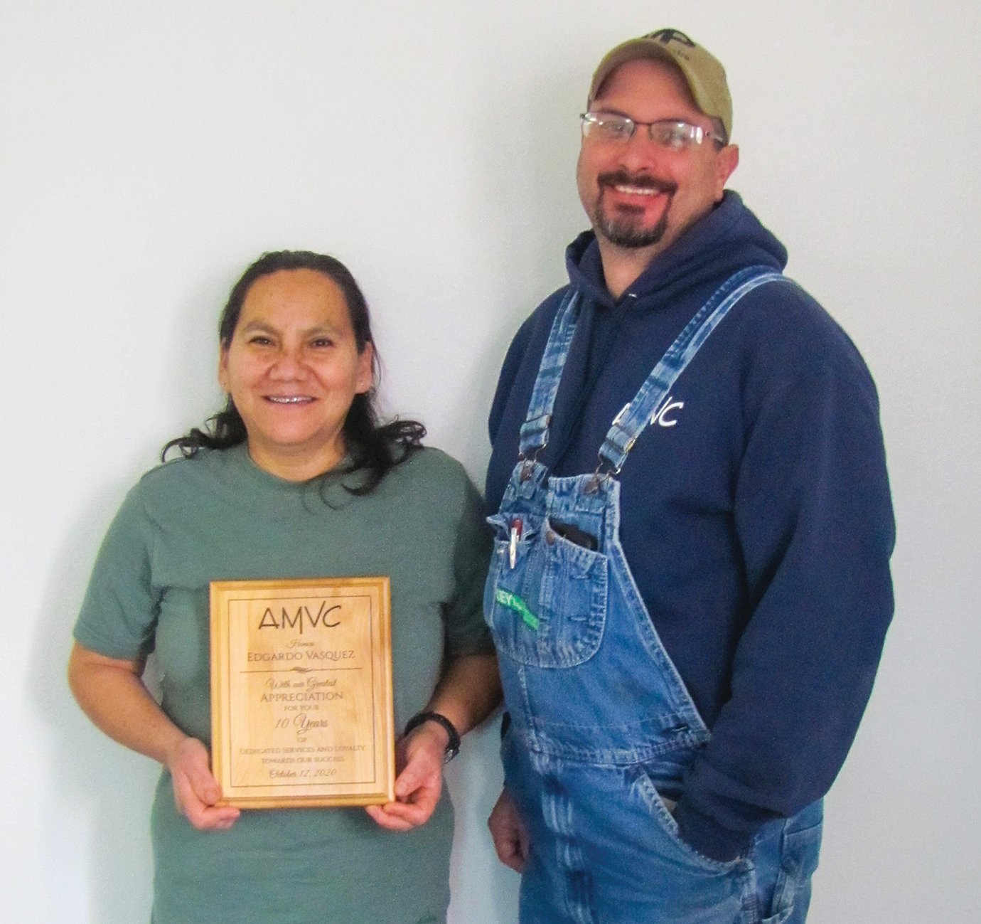 Nancy Diaz, left, accepts plaque in honor of her work anniversary from farm manager, Mickey Parks.