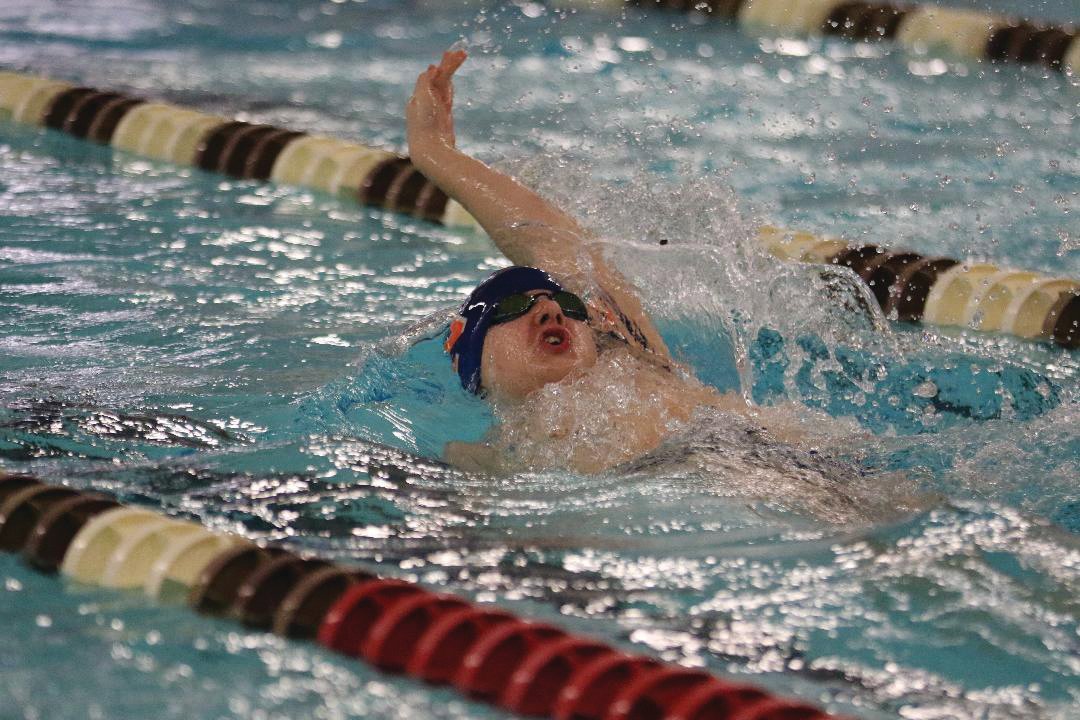 North Montgomery’s Jamason Burget swims in the 100 backstroke for the Chargers.