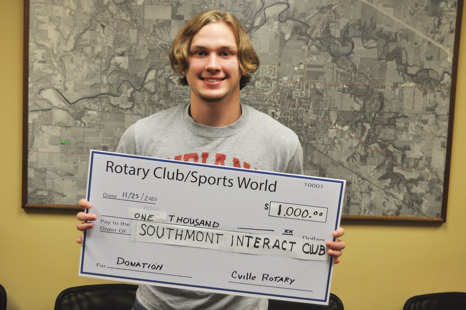 Southmont Interact Club President Aidan Portwood accepts a $1,000 check from the Crawfordsville Rotary Club. Interact is the youth arm of Rotary, and student members raise money to provide a Christmas party for a school in Haiti. The grant will also allow the group to plan a spring activity. The group has also worked with the Montgomery County Youth Service Bureau to promote child abuse prevention.