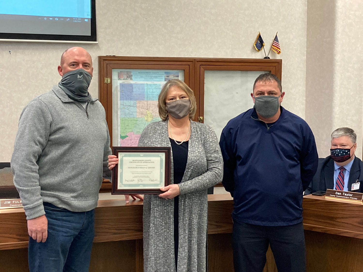 Former Montgomery Superior Court 2 Judge Peggy Lohorn, center, accepts a certificate of appreciation from the Board of Commissioners Monday. Also pictured are commissioners Dan Guard and Jim Fulwider.