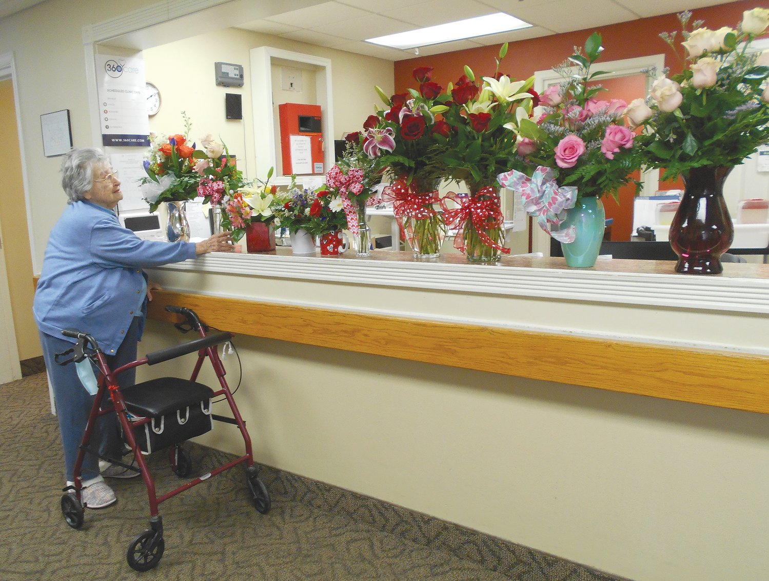 Irene Bratton, a resident of Hickory Creek at Crawfordsville, admires a special surprise flower delivery from Just Because Flower Shop. Bratton selected an arrangement for her room. Sherry Bratcher, Hickory Creek activities director, said the random act of kindness displayed by the local floral shop brightened the residents