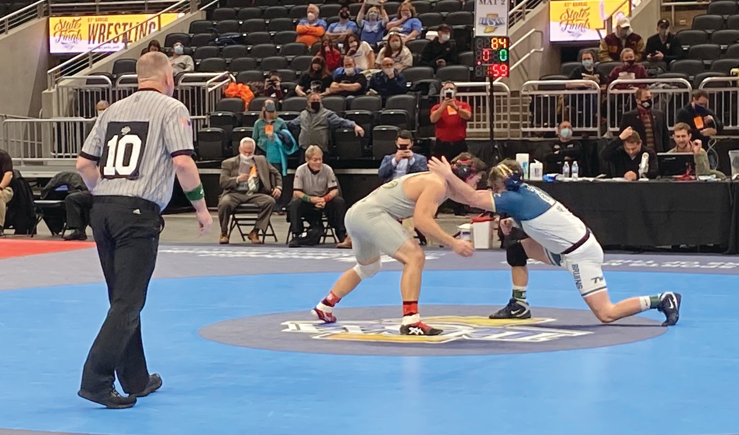 Southmont's Riley Woodall competes against Tri-West's Dominic Pugliese in the opening round of the state finals on Friday night at Bankers Life Fieldhouse.