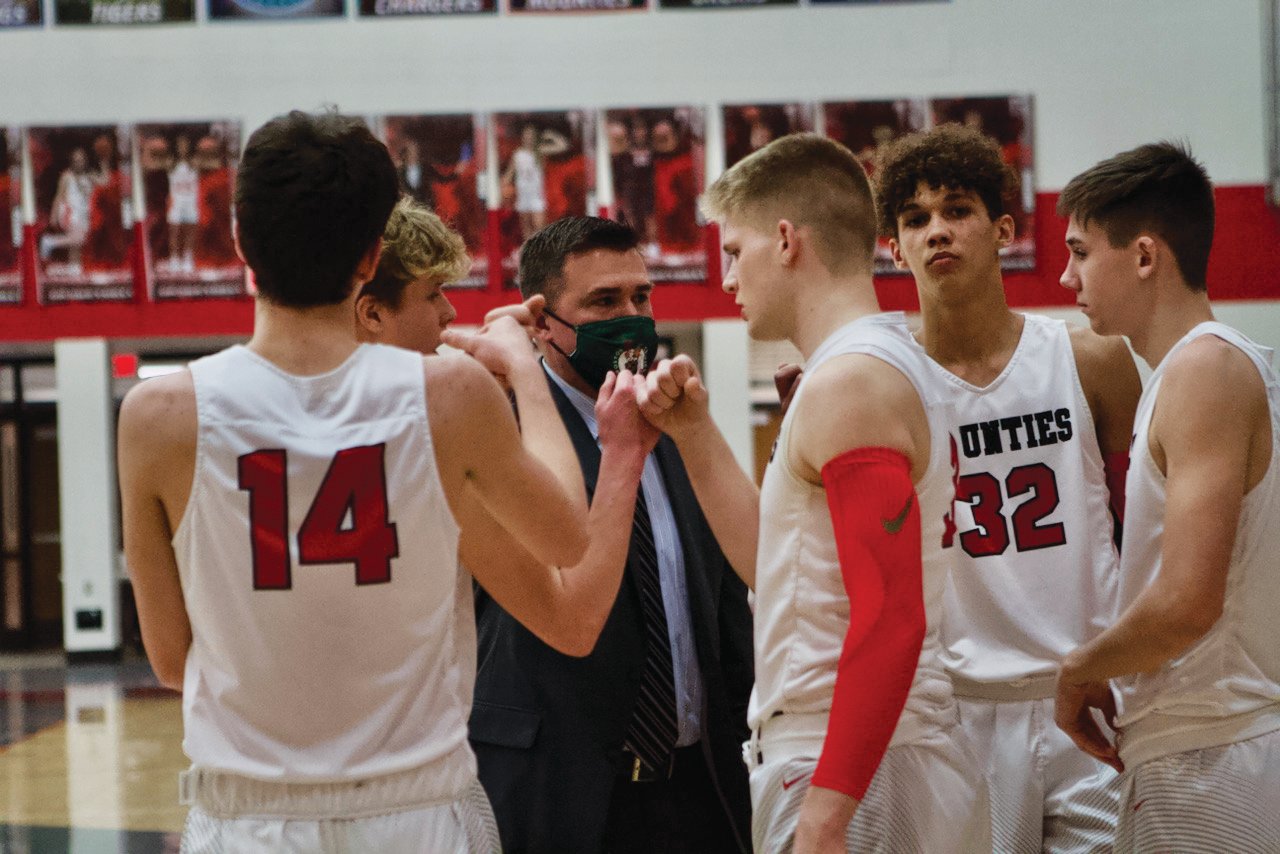Southmont assistant coach Dan Chadd breaks down the huddle on Friday night against Scecina with the Mounties starting lineup, which includes his son, Carson.